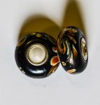 Pandora bead, on black base creme coloured spott with brown